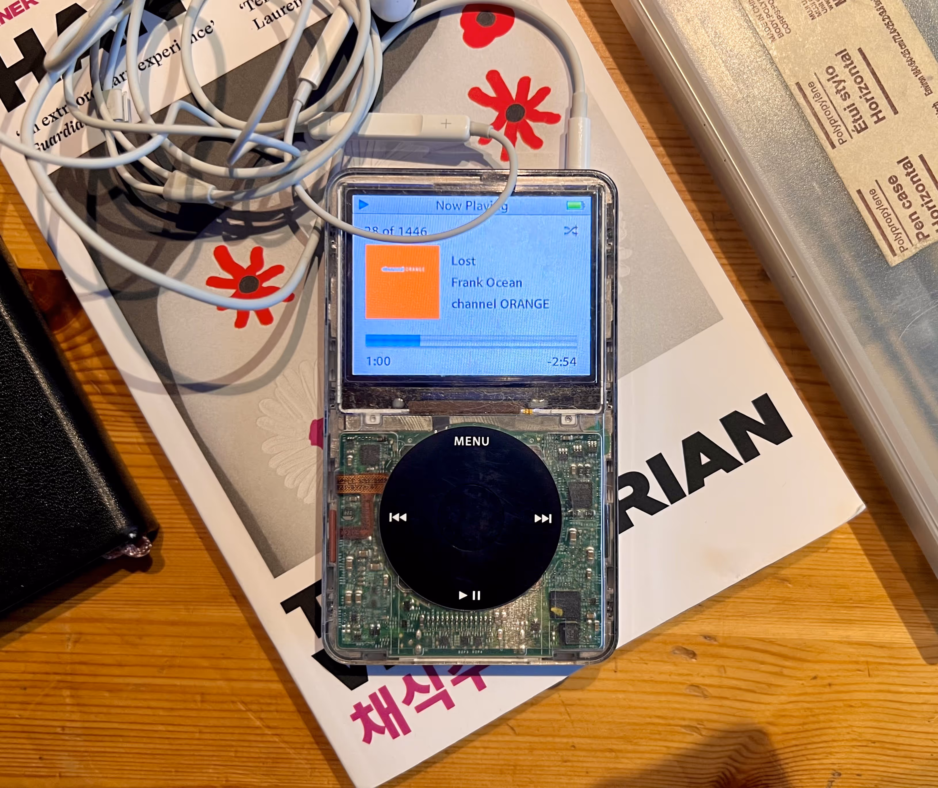 iPod classic 5.5 video, book in the background. The song playing is Lost, by Frank Ocean
