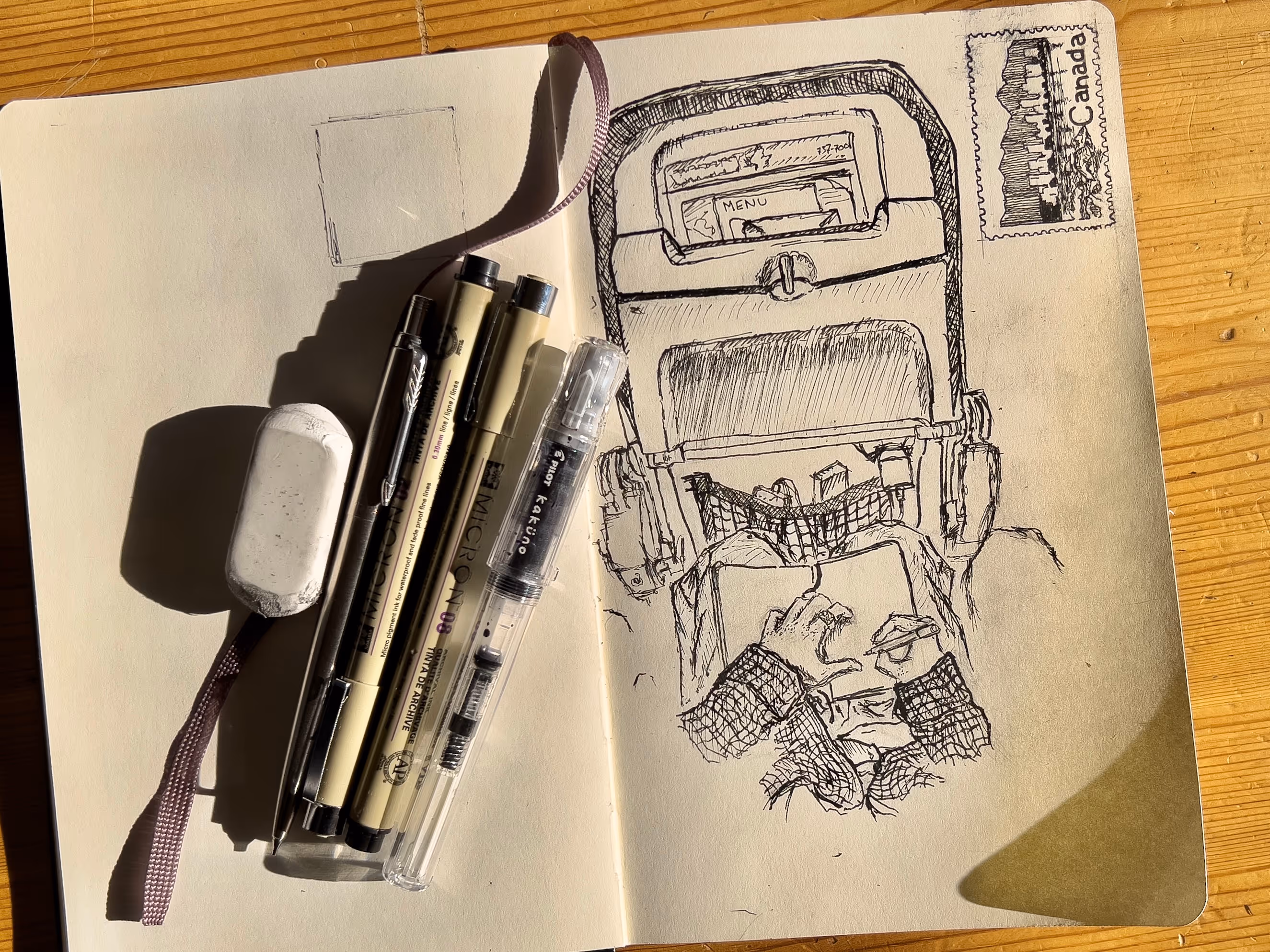 sketch book drawing with pens above.