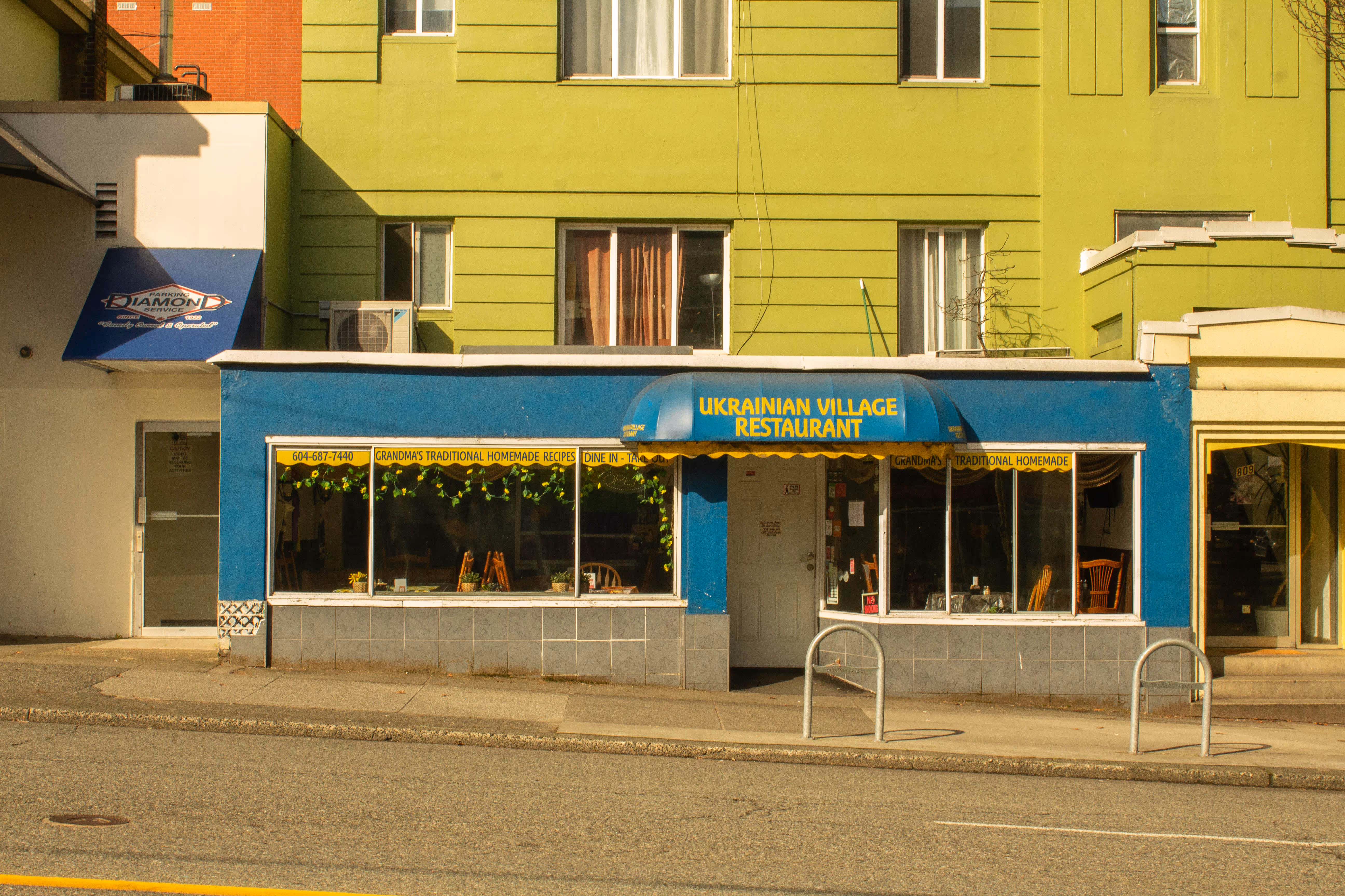 A small Ukranian diner, the building is blue and yellow.